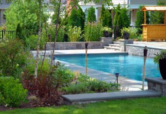 GA Landscape Design in-ground pool with stone and mature plantings create a backyard oasis in this NJ landscape