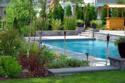 GA Landscape Design in-ground pool with stone and mature plantings create a backyard oasis in this NJ landscape