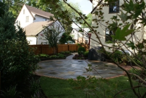 A beautiful stone and brick circular patio in a Maplewood NJ backyard