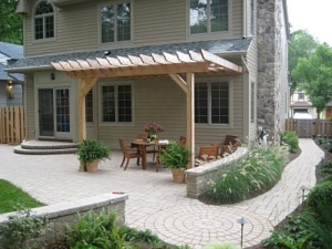 A paver walkway leads one through the landscaping to the paver patio and entertaining area of this backyard