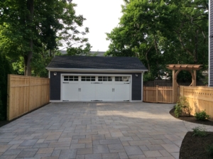 A paver driveway with wood fencing complete this Summit NJ Landscape Design