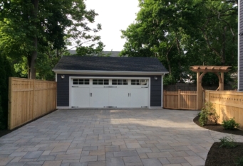 A paver driveway with wood fencing complete this Summit NJ Landscape Design
