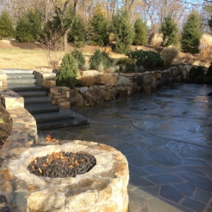 A gas fire pit, and built in stairs leading to the rest of the landscape complete this gorgeous natural stone patio