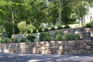 Stacked Stone Walls with plantings make for an inviting landscape design