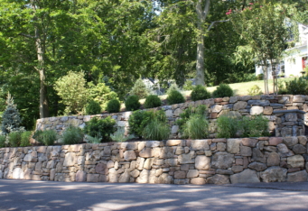 Stacked Stone Walls with plantings make for an inviting landscape design