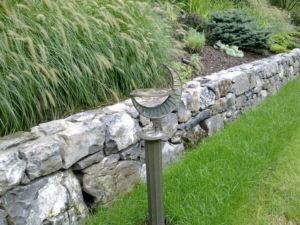 Moss Rock Stone Wall with new plantings create scenic landscaping
