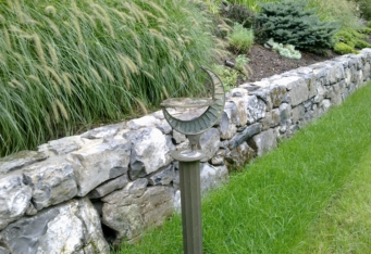 Moss Rock Stone Wall with new plantings create scenic landscaping