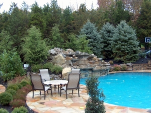 A Waterfall into a pool in this Scotch Plains NJ landscaped backyard