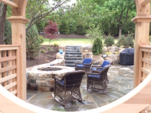 Basking Ridge NJ Stone Fire Pit with seating area in this backyard design