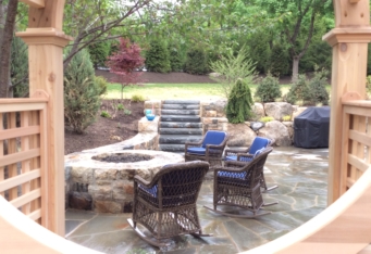 Basking Ridge NJ Stone Fire Pit with seating area in this backyard design