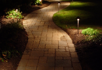 Landscape Lighting lights up a walkway at night