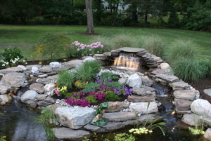 Scotch Plains NJ Landscape Lighting lights up a waterfall and pond in this NJ backyard